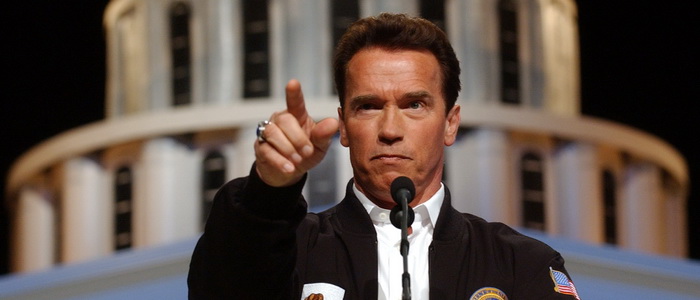 Gov. Arnold Schwarzenegger points to a reporter while taking questions during a news conference at Cal Expo in Sacramento, Calif., Wednesday, Feb. 23, 2005. Standing in front of a mock-up of the state Capitol, Schwarzenegger called on lawmakers to approve a constitutional amendment that automatically cuts state spending across the board if spending execeeds state revenues. (AP Photo/Rich Pedroncelli)