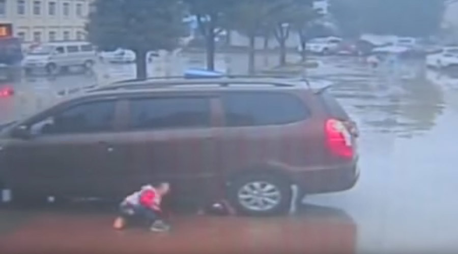 Close call: Two Chinese toddlers survive being run over by a car