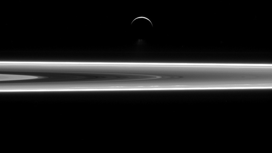 Saturn’s icy, crescent moon shines above its rings in stunning NASA (photo)