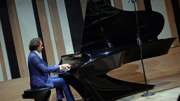 Hungarian pianist and creator Gergely Boganyi plays on a new piano during a presentation for the press at the Budapest Music Center on January 20, 2015. The fundamental difference of the Bog&Atilde;&iexcl;nyi Piano to a traditional piano is the sound-board made of multi-layered carbon-fibre with a rippled surface that is sprung and detached from the piano frame. The new material makes the piano resistant to exterior conditions like heat or humidity and prevents the soundboard from breakage. AFP PHOTO / ATTILA KISBENEDEK        (Photo credit should read ATTILA KISBENEDEK/AFP/Getty Images)