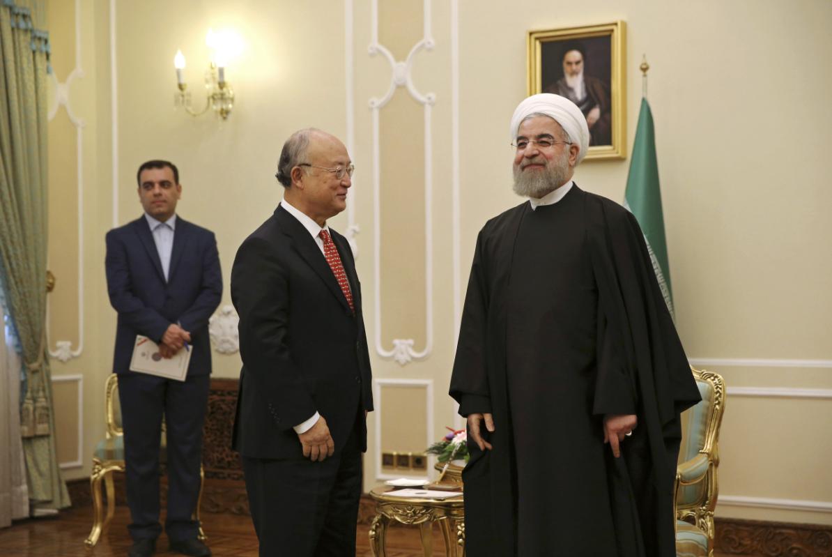 Iranian President Hassan Rouhani, right, welcomes U.N. nuclear chief Yukiya Amano for their meeting in Tehran, Iran, Sunday, Sept. 20, 2015. Rouhani told Amano on Sunday that his agency should be fair in its implementation of a nuclear deal reached between Iran and the world powers, according to a report on Rouhani's website. (AP Photo/Vahid Salemi)