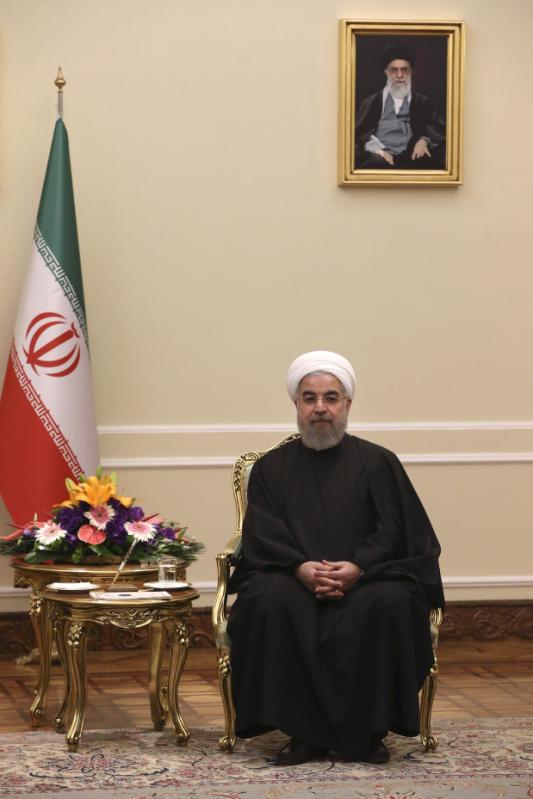 Iranian President Hassan Rouhani sits during a meeting with U.N. nuclear chief Yukiya Amano, in Tehran, Iran, Sunday, Sept. 20, 2015.  Iran's state TV reported Amano arrived in Tehran Sunday to 