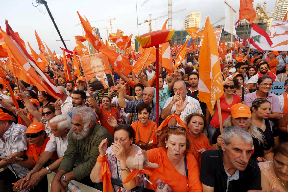 Supporters of the Free Patriotic Movement (FPM) carry flags and a broom stick during a protest in Beirut, Lebanon, September 4, 2015. Thousands of protesters rallied in Beirut on Friday to support a leading Christian politician's call for a presidential election, in the midst of a political crisis that has paralysed the government and parliament. REUTERS/Mohamed Azakir