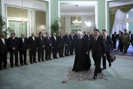 Iranian President Hassan Rouhani (C) walks with Chinese President Xi Jinping (R) during a welcoming ceremony in Tehran, Iran January 23, 2016.REUTERS/President.ir/Handout via Reuters