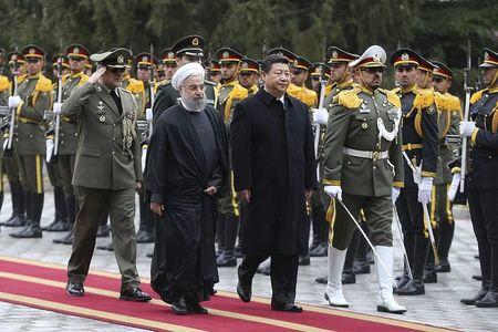 Iranian President Hassan Rouhani and Chinese President Xi Jinping review the honour guard during a welcoming ceremony in Tehran, Iran January 23, 2016.REUTERS/President.ir/Handout via Reuters