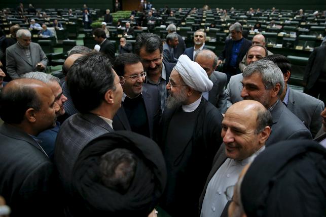 Iranian President Hassan Rouhani (center R) is greeted during a session at the Iranian parliament to present the draft budget for the next Iranian fiscal year in Tehran, January 17, 2016. REUTERS/President.ir/Handout