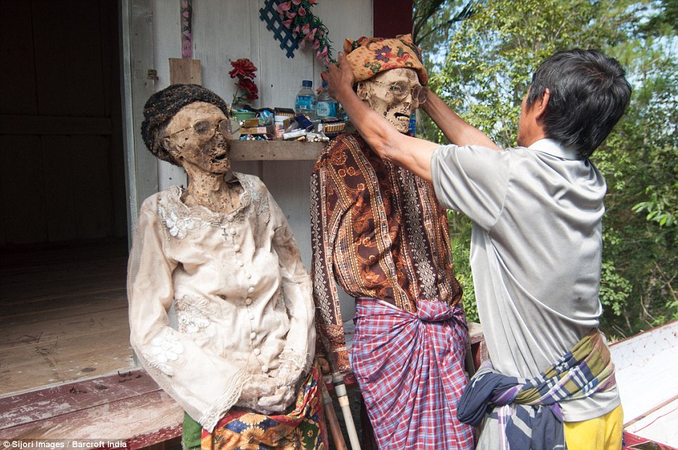 Zombie chic: Indonesian province’s bizarre annual ritual of digging up its dead to give them a wash, groom and dress them in new clothes
