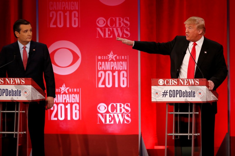 Republican U.S. presidential candidate Senator Ted Cruz (L) looks on as businessman Donald Trump speaks at the Republican U.S. presidential candidates debate sponsored by CBS News and the Republican National Committee in Greenville, South Carolina February 13, 2016. REUTERS/Jonathan Ernst