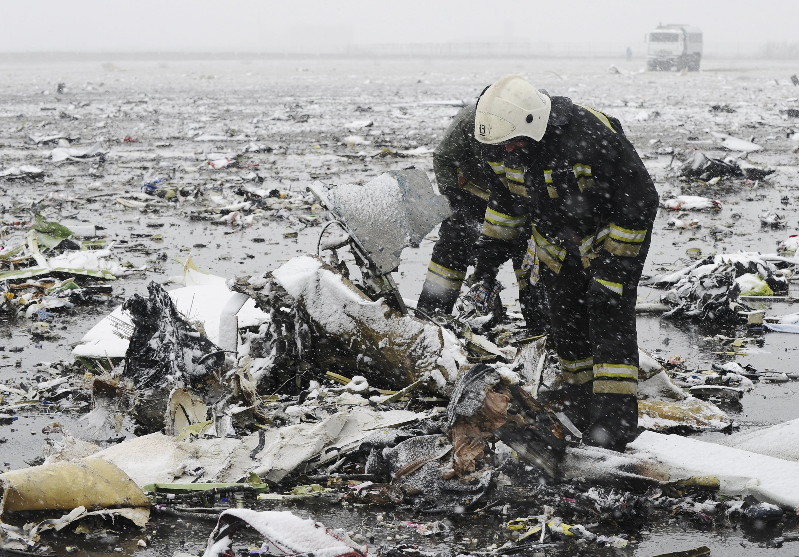 Emergencies Ministry members search the wreckage at the crash site of Flight number FZ981, a Boeing 737-800 operated by Dubai-based budget carrier Flydubai, at the airport of Rostov-On-Don, Russia, March 19, 2016. REUTERS/Stringer  EDITORIAL USE ONLY. NO RESALES. NO ARCHIVE