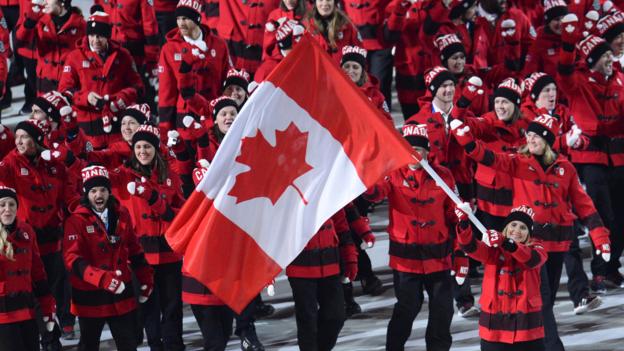 Canada's flag bearer, ice hockey player Hayley Wickenheiser leads her national delegation during the Opening Ceremony of the Sochi Winter Olympics at the Fisht Olympic Stadium on February 7, 2014 in Sochi. AFP PHOTO / JONATHAN NACKSTRAND        (Photo credit should read JONATHAN NACKSTRAND/AFP/Getty Images)