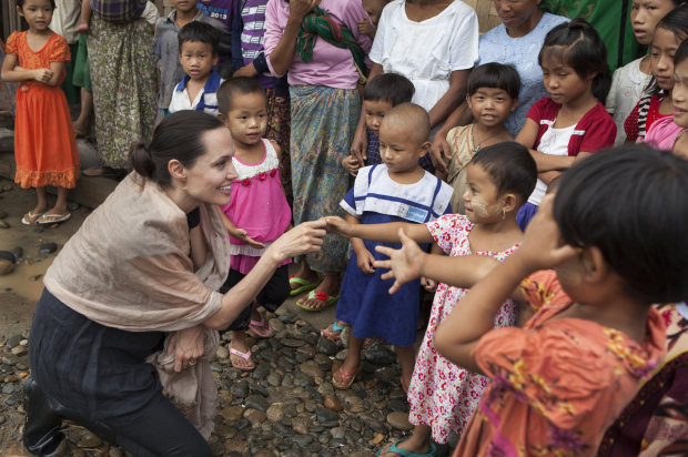 MYITKYINA, MYANMAR - JULY 30: In this handout photo provided by the Maddox Jolie-Pitt Foundation, actress and activist Angelina Jolie Pitt meets children during a visit to Ja Mai Kaung Baptist refugee camp on July 30, 2015 in Myitkyina, Myanmar. Angelina Jolie Pitt is a Special Envoy of UN High Commissioner for Refugees since her 2012 appointment.  (Photo by Tom Stoddart/Getty Images Reportage/Maddox Jolie-Pitt Foundation via Getty Images)