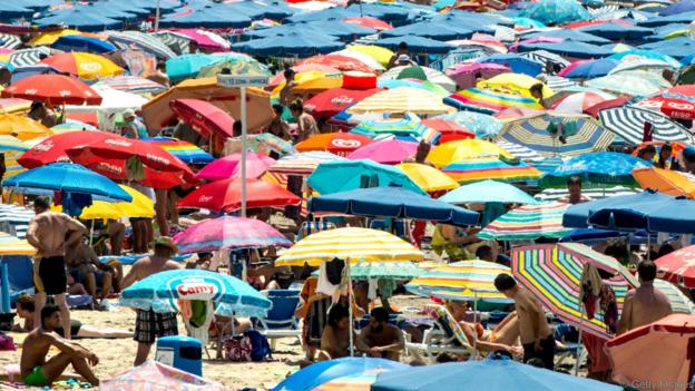 BENIDORM, SPAIN - JULY 22:  People sunbathe at Poniente Beach on July 22, 2015 in Benidorm, Spain. Spain has set a new record for visitors, with 29.2 million visitors in June, 4.2% more than the same period in 2014. Spain is also expected to be the main destination of tourists seeking a value-for-money all-inclusive holiday after the Tunisia attack.  (Photo by David Ramos/Getty Images)