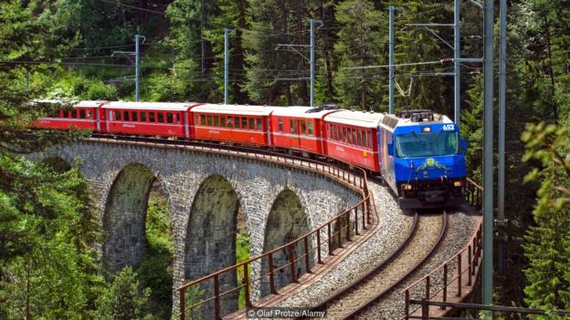 CBNCJW Alpine Express train at the Landwasser Viaduct in the Swiss Alps, Switzerland