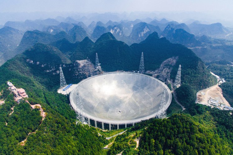 In this Saturday, Sept. 24, 2016 photo released by Xinhua News Agency, an aerial view shows the Five-hundred-meter Aperture Spherical Telescope (FAST) in the remote Pingtang county in southwest China's Guizhou province. China has begun operating the world's largest radio telescope to help search for extraterrestrial life. (Liu Xu/Xinhua via AP)
