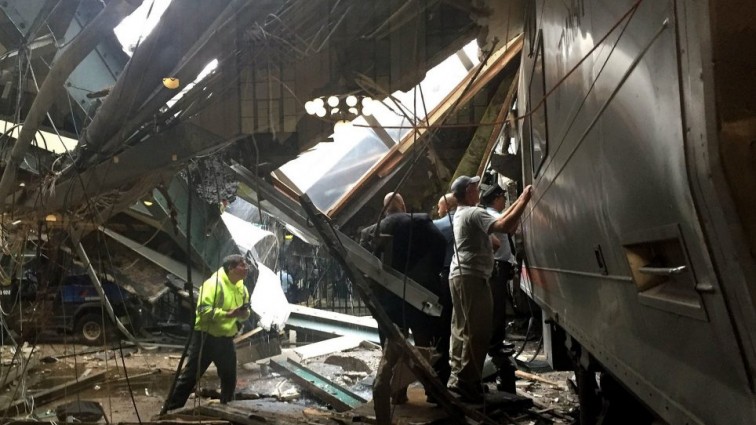 One confirmed dead and 100 injured after train crashes into station wall
