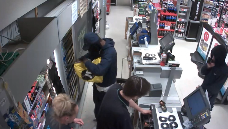 Terrifying CCTV shows moment thugs rob Co-op armed with handgun and a knife