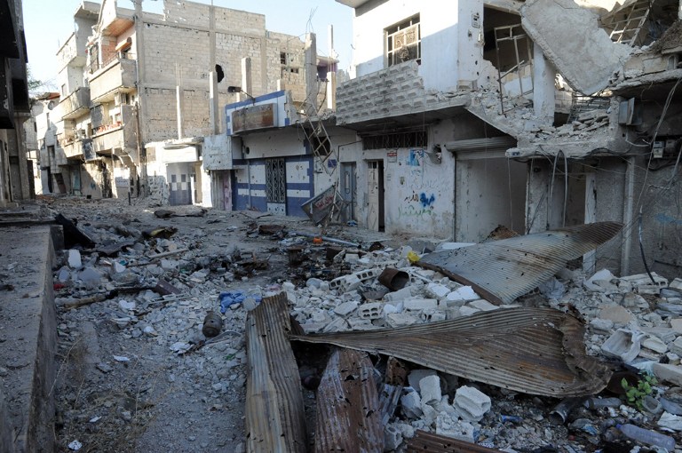 A picture taken on November 13, 2013, shows debris and damaged buildings in the town of Hujeira south of the Syrian capital Damascus. The Syrian army has seized a town south of Damascus in its campaign to cut off eastern neighbourhoods of the capital that are home to rebels, state television said. AFP PHOTO/STR